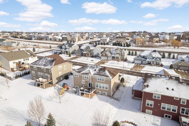 snowy aerial view with a residential view