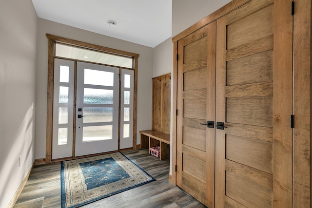 foyer entrance featuring wood finished floors and baseboards