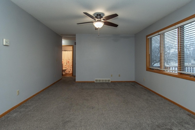 unfurnished room with ceiling fan and carpet floors