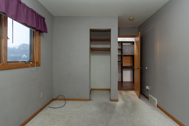 unfurnished bedroom featuring carpet floors and a closet