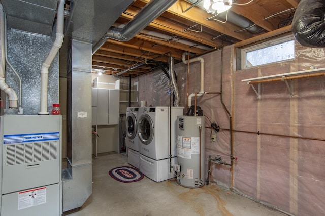 laundry area featuring washing machine and clothes dryer and water heater