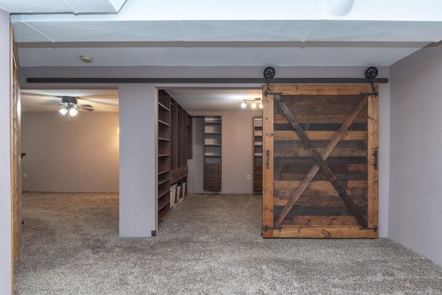 interior space with carpet flooring and a barn door