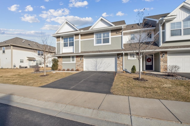 view of property with a garage and a front lawn