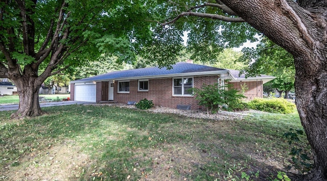 single story home featuring a garage and a front yard