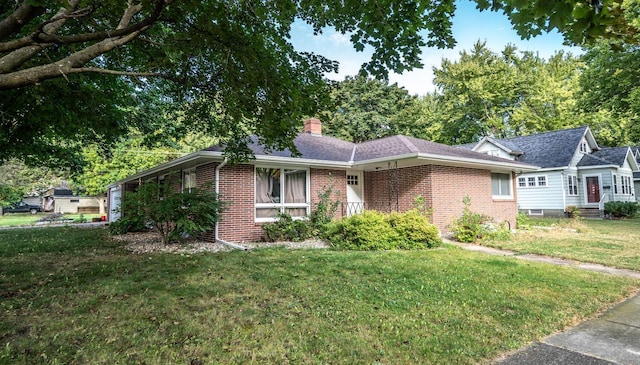 ranch-style home with a front lawn