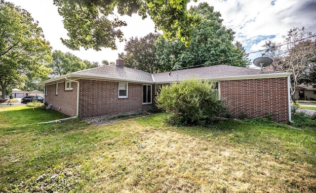 rear view of property featuring a lawn