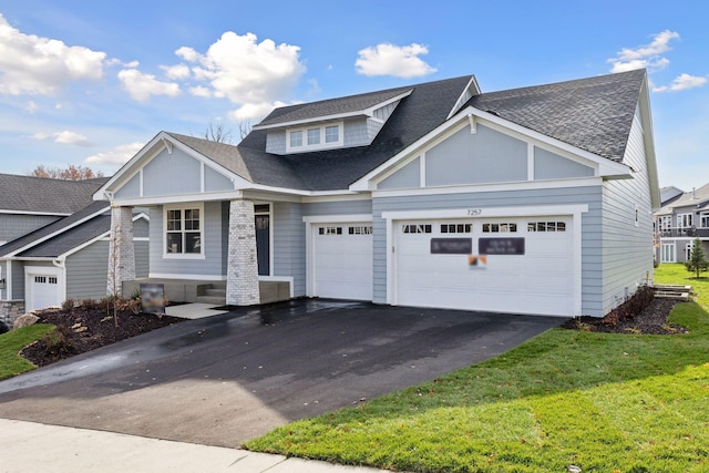 view of front facade with a garage and a front lawn