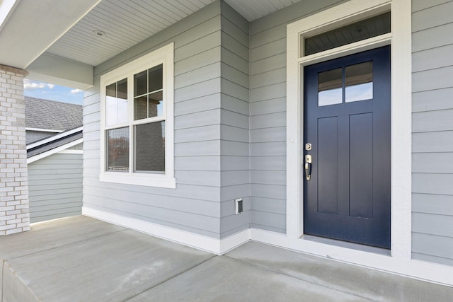 view of exterior entry featuring a porch