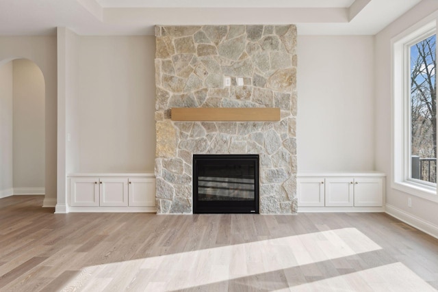 unfurnished living room with a fireplace and light hardwood / wood-style flooring