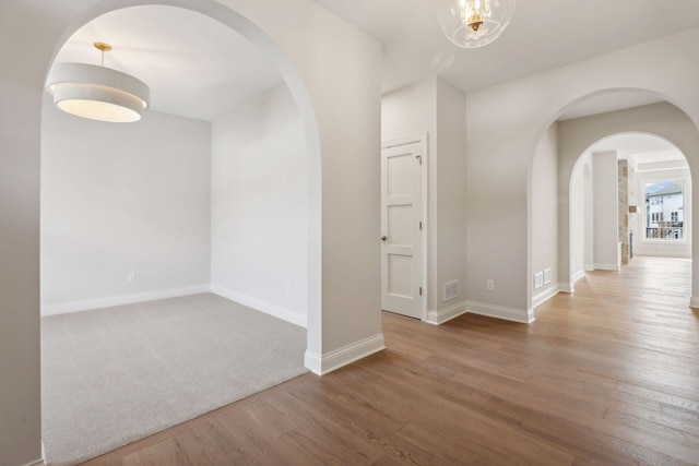 empty room with hardwood / wood-style floors