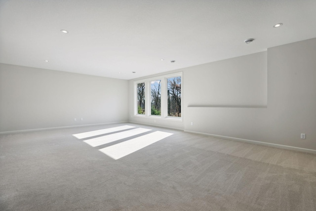 unfurnished room with light colored carpet