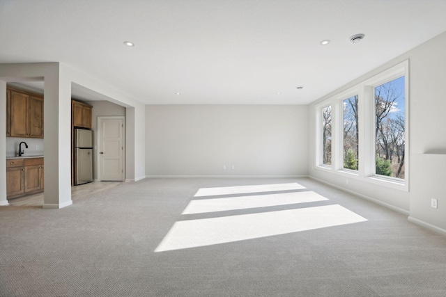 interior space featuring sink and light colored carpet