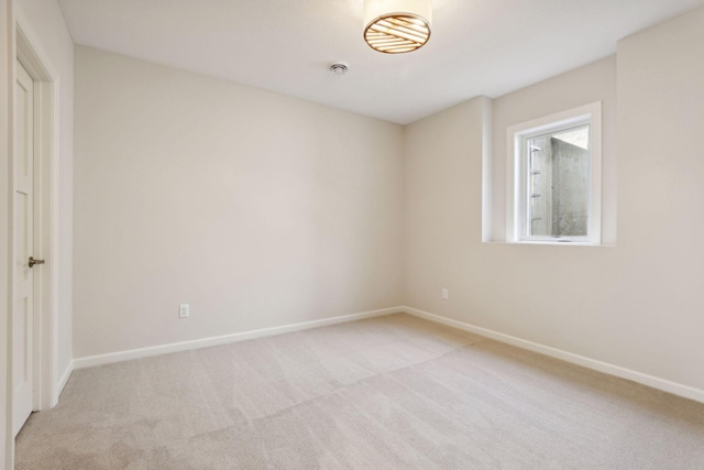 empty room featuring light colored carpet