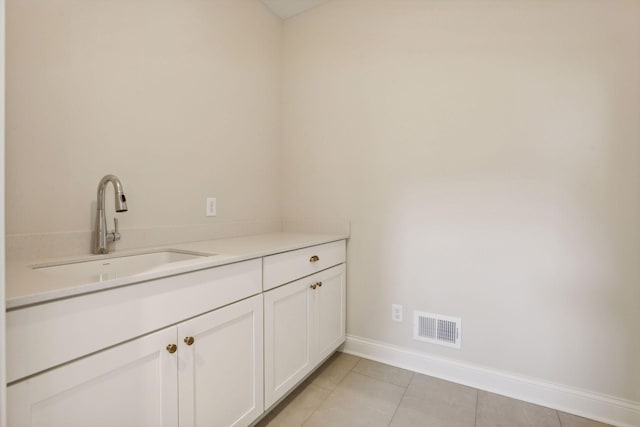 bathroom featuring tile patterned flooring and vanity