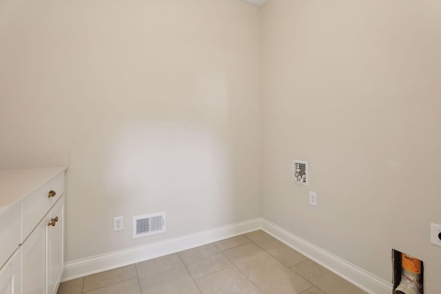 laundry area with washer hookup, light tile patterned flooring, cabinets, and hookup for an electric dryer