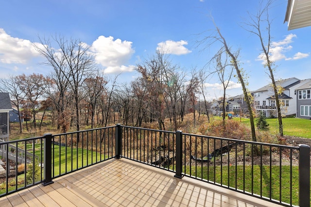 wooden deck featuring a lawn