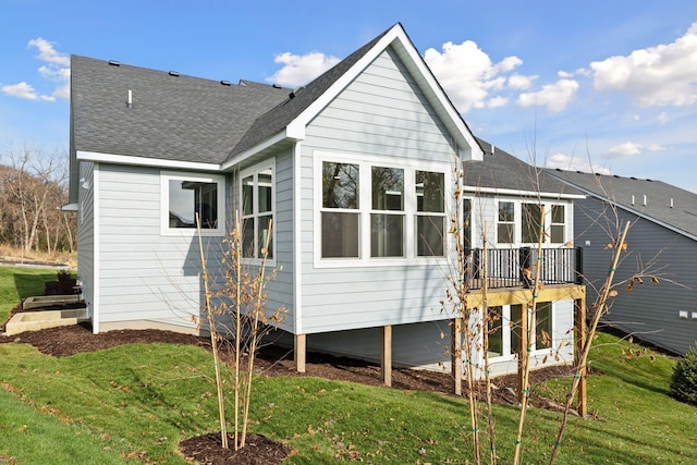 rear view of property with a yard