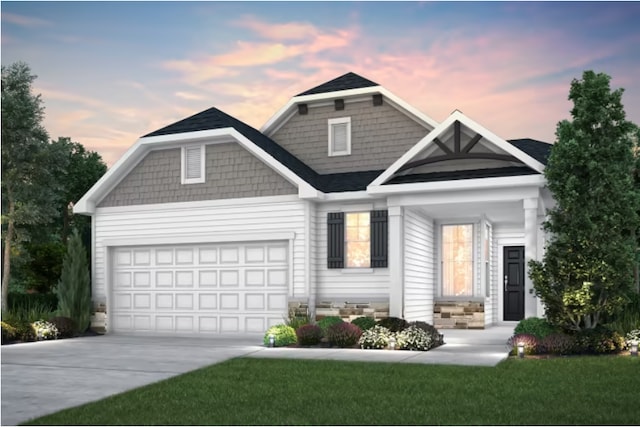 view of front of home with a yard and a garage