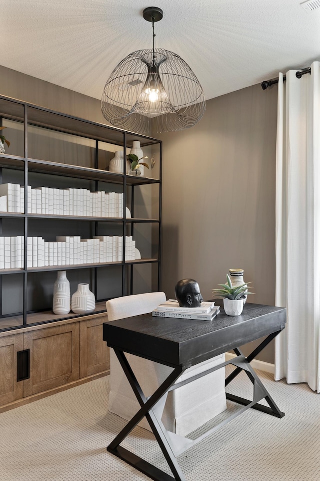 office area featuring light colored carpet and a textured ceiling