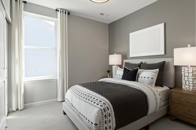 bedroom with light colored carpet