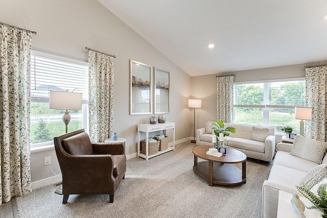 living room featuring carpet flooring, vaulted ceiling, and a wealth of natural light