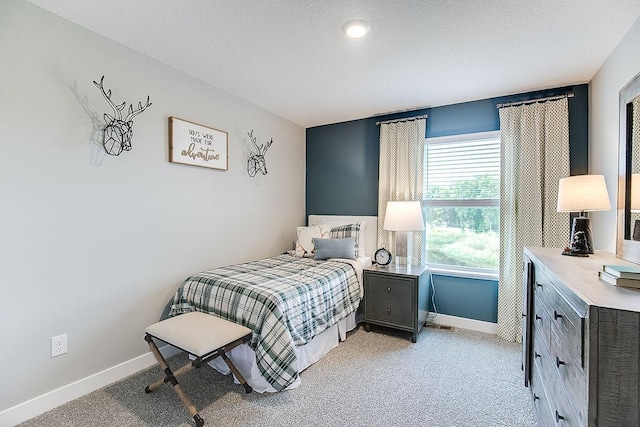 carpeted bedroom with a textured ceiling