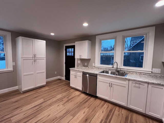 kitchen featuring white cabinetry, dishwasher, light hardwood / wood-style flooring, and sink