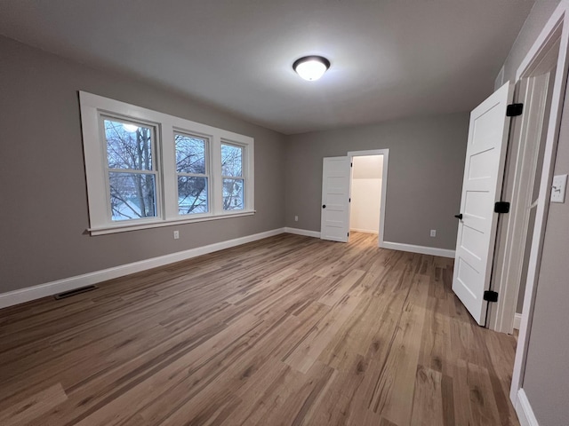 unfurnished bedroom with light wood-type flooring