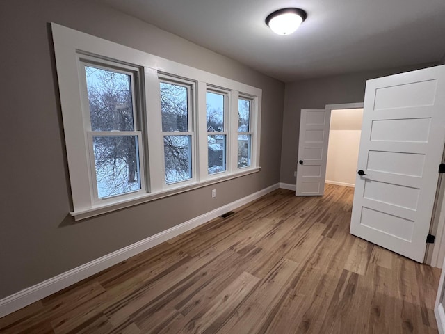 unfurnished bedroom featuring light wood-type flooring