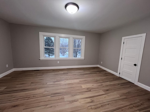 unfurnished room with hardwood / wood-style floors