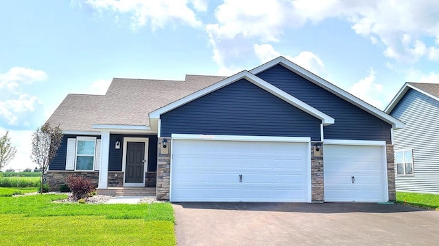 craftsman-style house featuring a garage and a front lawn