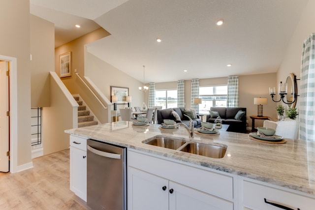 kitchen with light stone countertops, stainless steel dishwasher, sink, light hardwood / wood-style floors, and white cabinetry