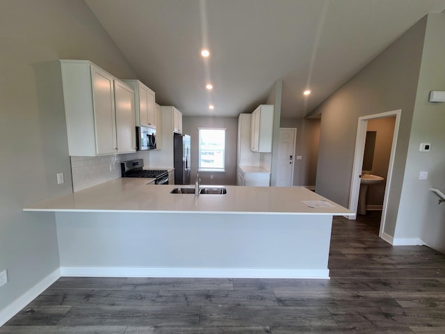 kitchen with kitchen peninsula, white cabinets, and appliances with stainless steel finishes