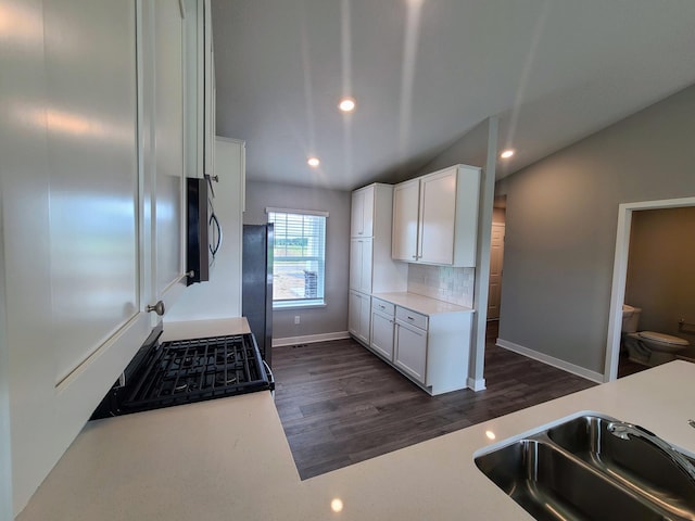 kitchen with white cabinets, dark hardwood / wood-style floors, sink, and stainless steel appliances