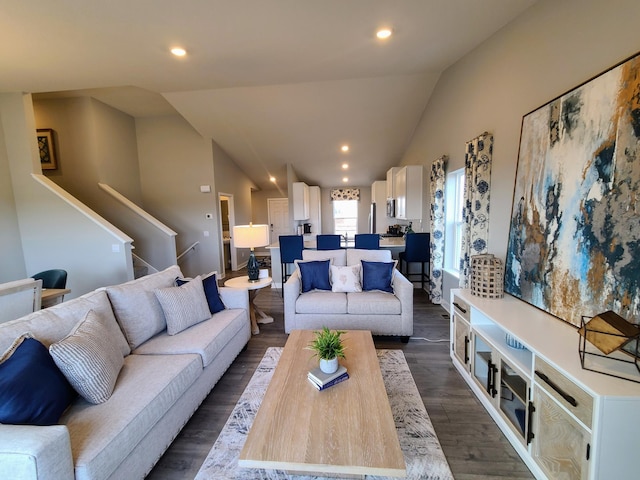 living room featuring dark hardwood / wood-style floors and vaulted ceiling