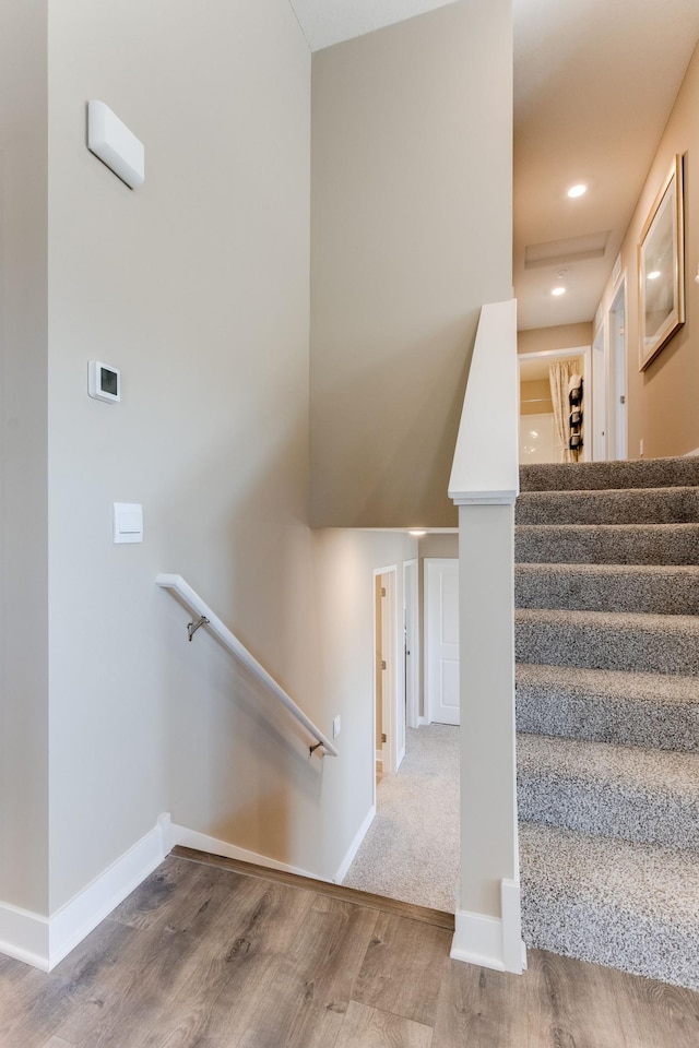 staircase with hardwood / wood-style floors