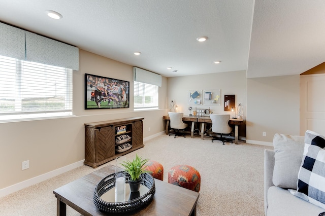 carpeted living room featuring a textured ceiling