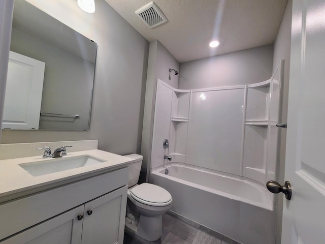 full bathroom with toilet, vanity, a textured ceiling, and tub / shower combination