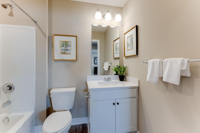 full bathroom featuring washtub / shower combination, vanity, and toilet