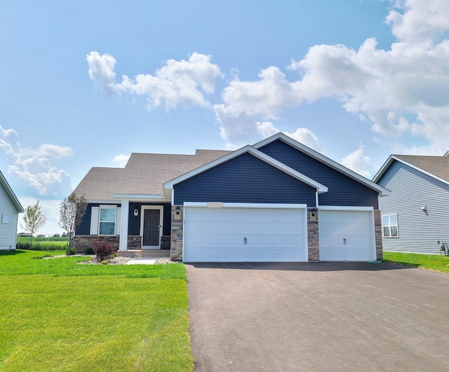 view of front of house with a front yard and a garage