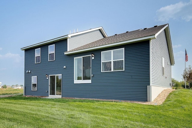 rear view of property with a yard