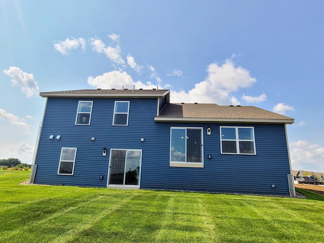 back of house with a yard