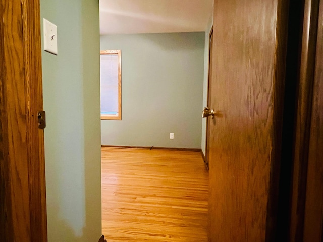 hallway with light hardwood / wood-style flooring