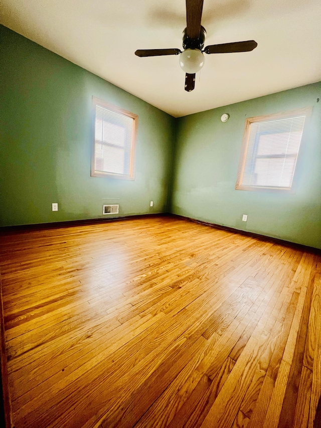 spare room featuring ceiling fan and light hardwood / wood-style flooring