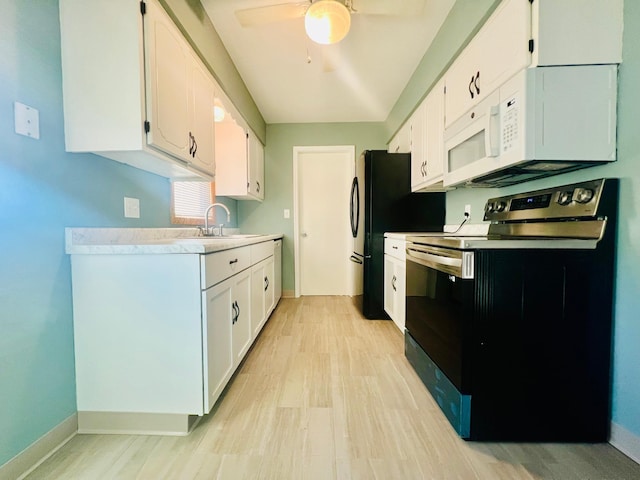 kitchen with white cabinets, sink, and electric range