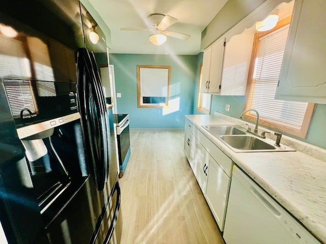 kitchen featuring dishwasher, sink, white cabinets, refrigerator with ice dispenser, and light hardwood / wood-style flooring