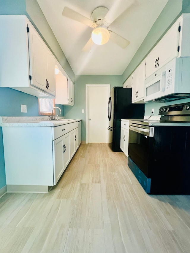 kitchen featuring electric stove, sink, ceiling fan, white cabinetry, and light hardwood / wood-style floors