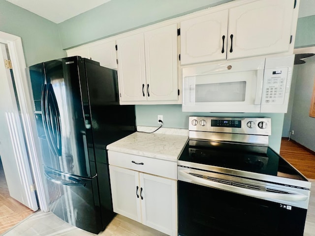 kitchen with white cabinetry, light hardwood / wood-style flooring, black refrigerator with ice dispenser, and stainless steel range with electric stovetop