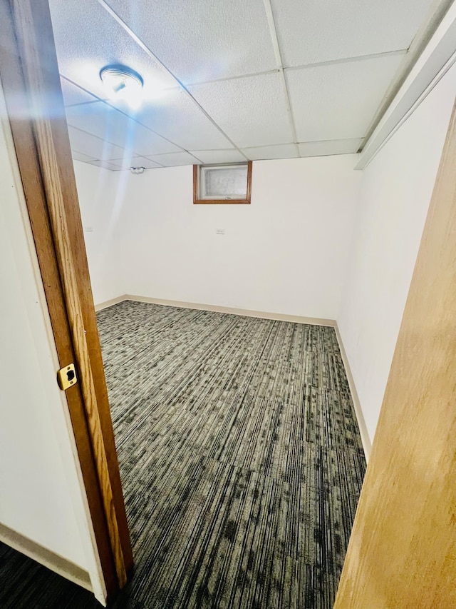 basement featuring a paneled ceiling