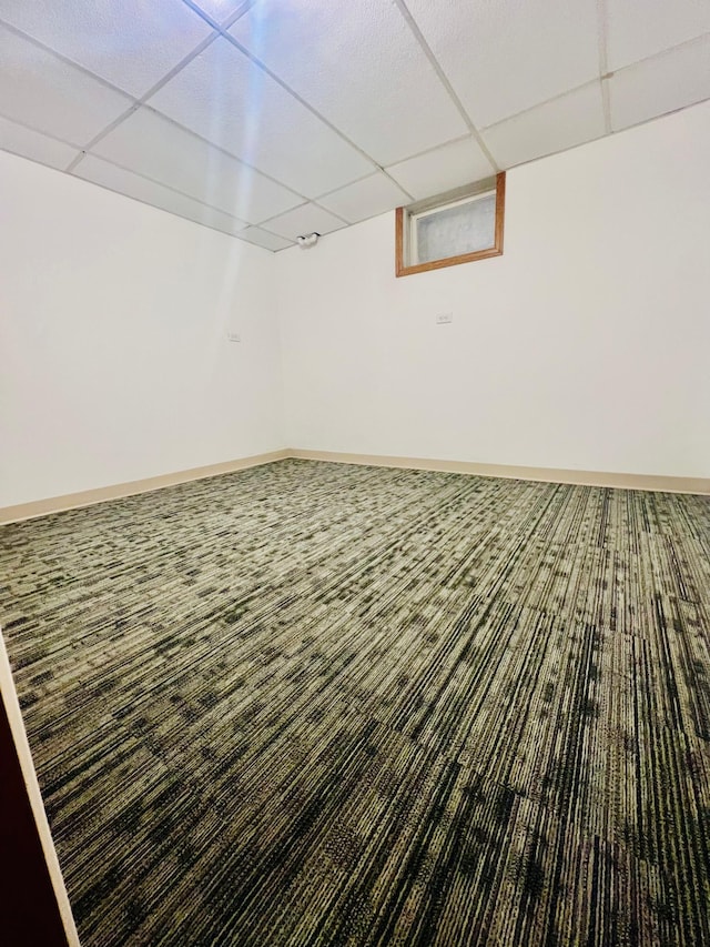 basement featuring carpet and a drop ceiling